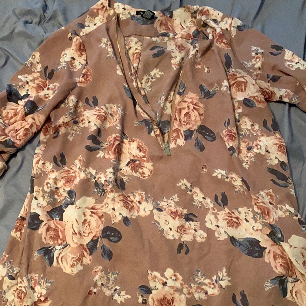 Short blouse more of a pinky purple floral.